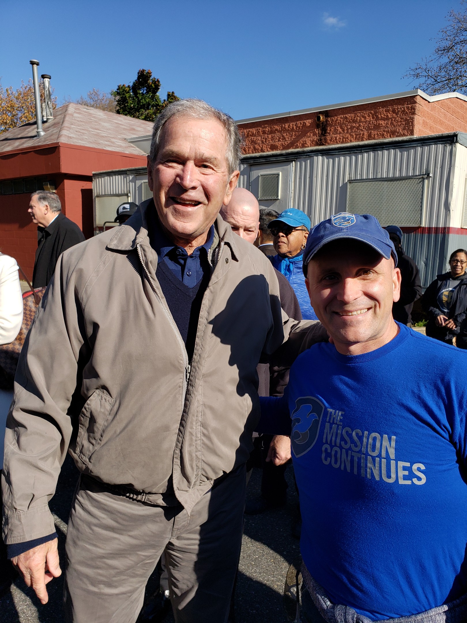 Former President George W. Bush dropped by a service project in Philadelphia, and poses for a photo with Platoon Leader Anthony Fedele.